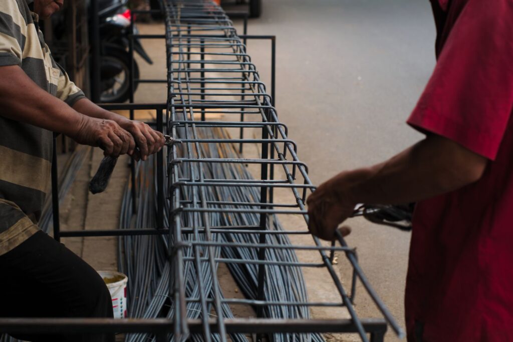 Construction workers assembling steel rebar reinforcement at a UAE construction site